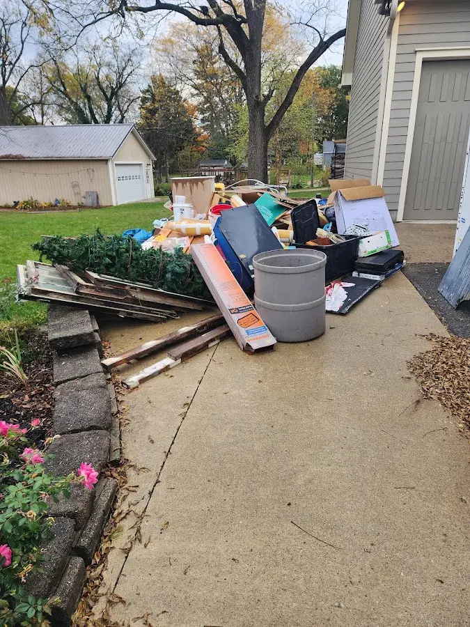 Dumpster being loaded with debris for 12 Yard Dumpster Rental in New Fairfield